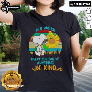 Happy Snoopy with sunflowers on a retro ladies tee, showcasing the message 'In a world where you can be anything, be kind'.