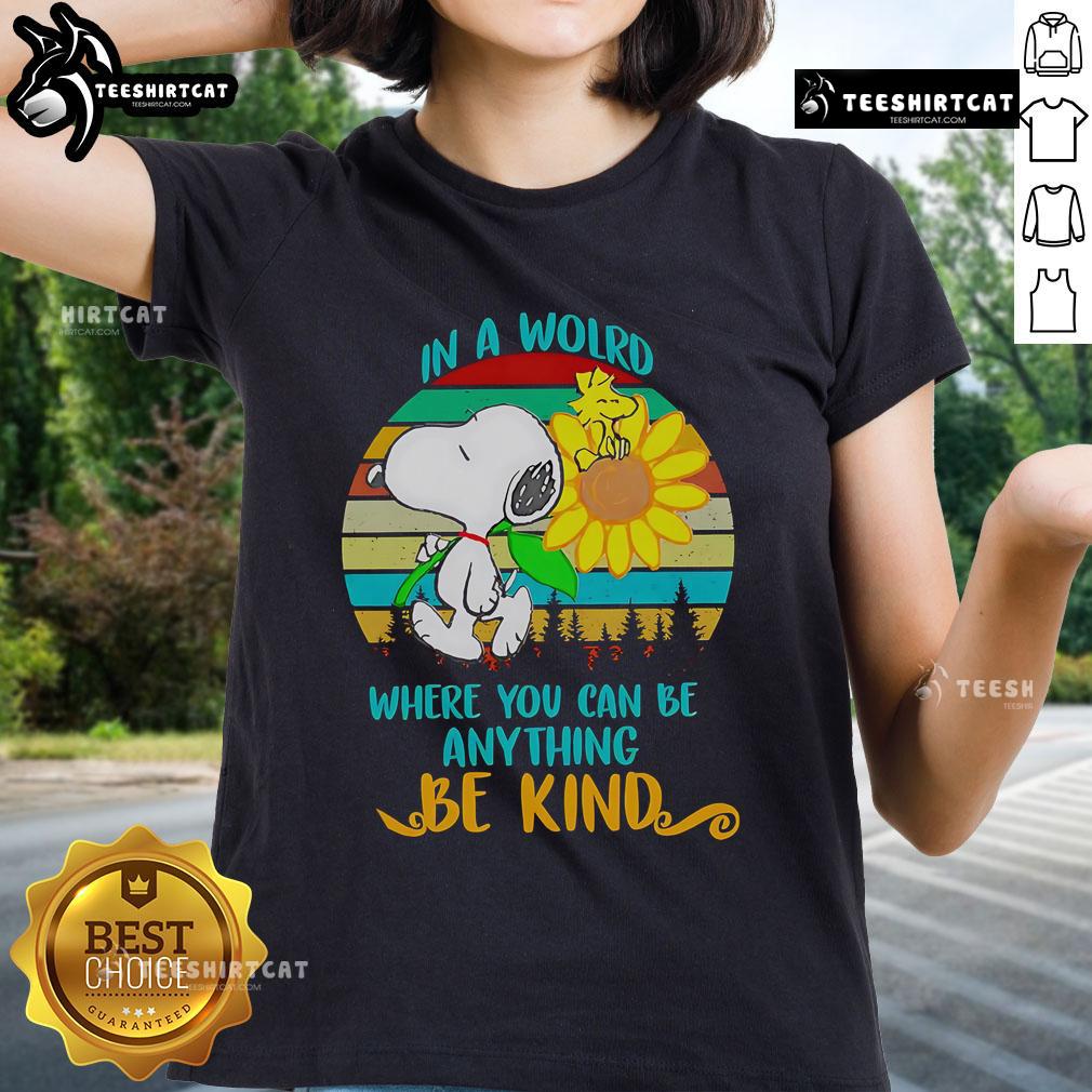 Happy Snoopy with sunflowers on a retro ladies tee, showcasing the message 'In a world where you can be anything, be kind'.