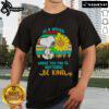 Alt Text: Happy Snoopy sunflower graphic on a retro t-shirt with the quote In a world where you can be anything, be kind.