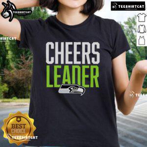 Seattle Seahawks cheerleader in a stylish ladies tee, showcasing team spirit at a game event.