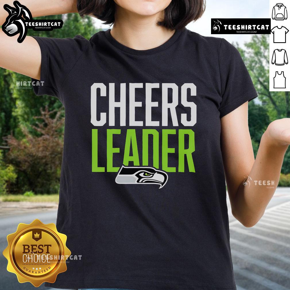 Seattle Seahawks cheerleader in a stylish ladies tee, showcasing team spirit at a game event.
