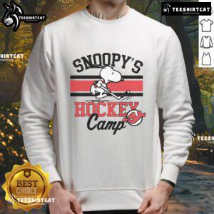 Snoopy wearing a New Jersey Devils sweatshirt at Snoopy's Hockey Camp, celebrating NHL teams in a fun design.
