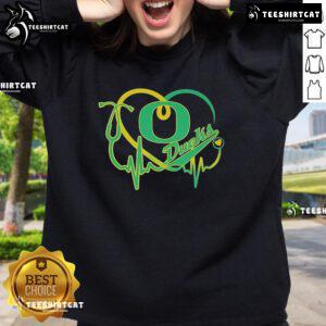 Alt Text: Official Oregon Ducks Caring Heartbeat Nurse Sweatshirt in green, perfect for nursing professionals and fans.