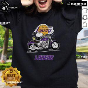 Official Snoopy and Woodstock driving a motorbike on a Los Angeles Lakers sweatshirt, perfect for fans and collectors.