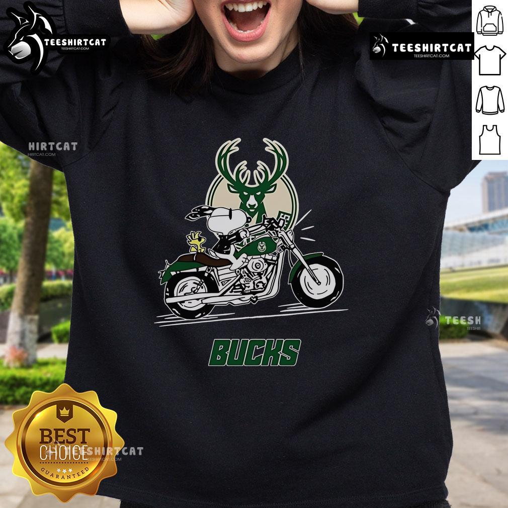 Alt Text: Snoopy and Woodstock riding a motorbike on a Milwaukee Bucks sweatshirt, showcasing a fun and vibrant design.