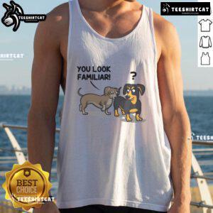 Funny dogs wearing 'You Look Familiar' tank tops, showcasing their playful personalities in a vibrant outdoor setting.
