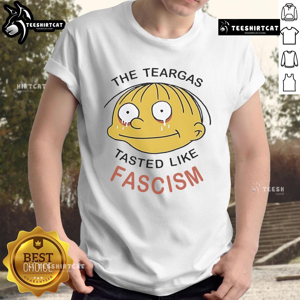 Official Ralph Wiggum 'The Teargas Tastes Like Fascism' T-Shirt featuring bold graphics and vibrant colors, perfect for fans.