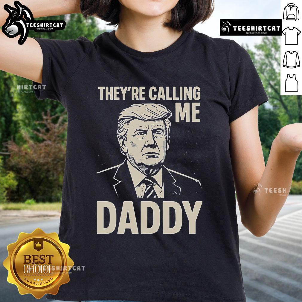 Alt Text: Official Trump 'They're Calling Me Daddy' Ladies Tee featuring bold graphics on a stylish women's shirt.