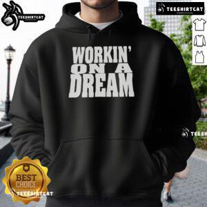 Alt Text: Official Workin' On A Dream Hoodie, featuring a stylish design perfect for casual wear and inspiring creativity.