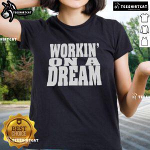 Official 'Workin On A Dream' ladies tee featuring a stylish design, perfect for casual wear and fan merchandise.