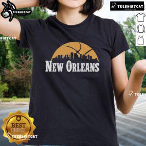 Alt Text: Premium New Orleans Pelicans cityscape skyline style 2025 ladies tee featuring vibrant team colors and design.