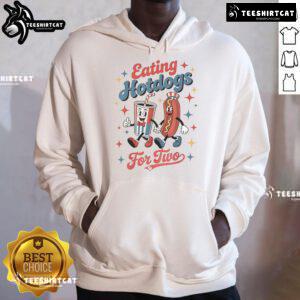 Couple enjoying hotdogs while wearing 'Nice Eating Hotdogs for Two' hoodies, perfect for food lovers and cozy outings.