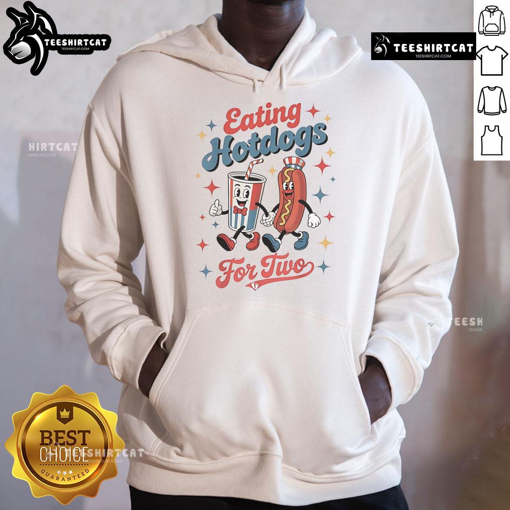 Couple enjoying hotdogs while wearing 'Nice Eating Hotdogs for Two' hoodies, perfect for food lovers and cozy outings.