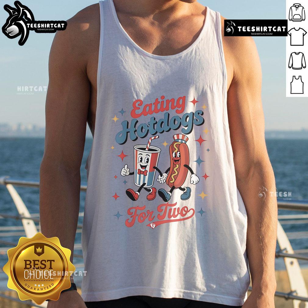 Couple enjoying hot dogs together while wearing a 'Nice Eating Hotdogs For Two' tank top at a sunny outdoor picnic.
