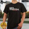 Official Let's Wrestle USA T-Shirt featuring bold graphics and vibrant colors, perfect for wrestling fans and enthusiasts.