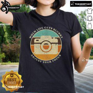 Alt Text: Vintage camera graphic on a ladies' tee with the quote When life gets blurry, adjust your focus.