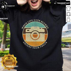 Alt Text: Vintage camera quote sweatshirt featuring When Life Gets Blurry, Adjust Your Focus design for photography lovers.