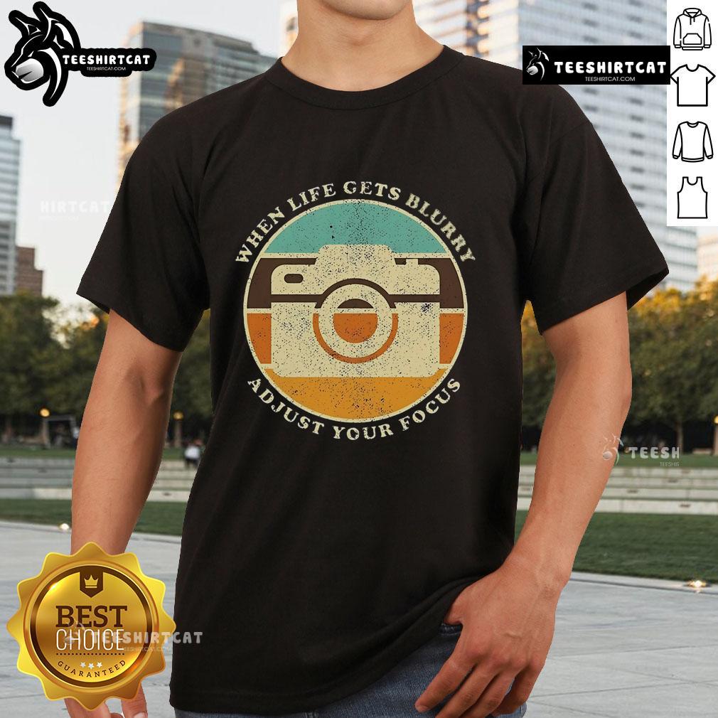 Vintage camera quote T-shirt: 'When Life Gets Blurry, Adjust Your Focus' design for photography enthusiasts.