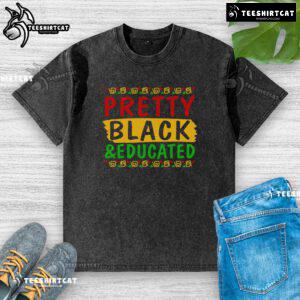 Pretty black educated washed t-shirt displayed on a wooden background, showcasing its stylish design and texture.