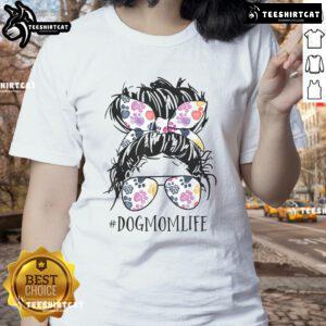 Pretty dog mom in a messy bun wearing a tee, celebrating Mother's Day with her furry friend.