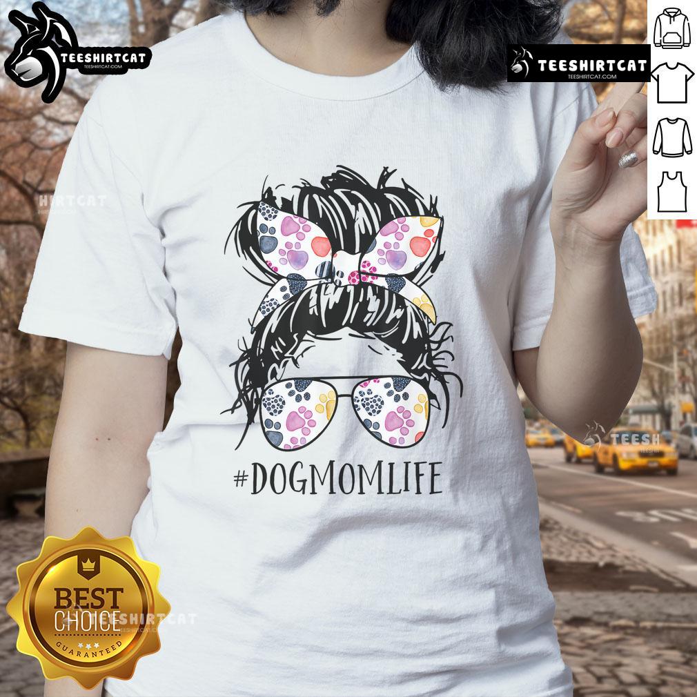 Pretty dog mom in a messy bun wearing a tee, celebrating Mother's Day with her furry friend.