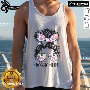 Pretty dog mom in a messy bun wearing a tank top for Mother's Day, showcasing love for her pet.