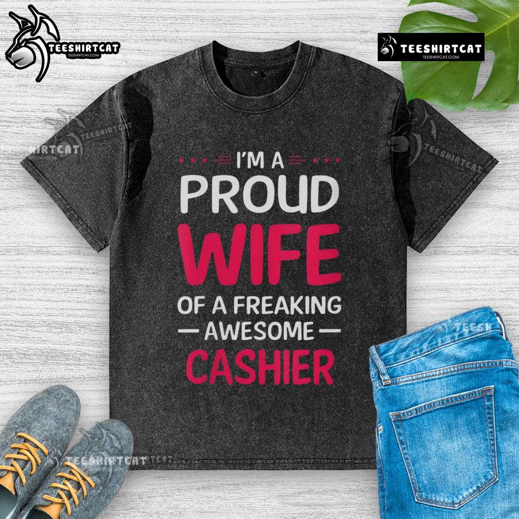 Pretty I'm a Proud Wife of a Freaking Awesome Cashier washed t-shirt displayed on a hanger against a bright background.