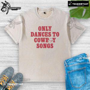 Good George Birge wearing a washed t-shirt, dancing joyfully to cowboy songs at a lively outdoor event.