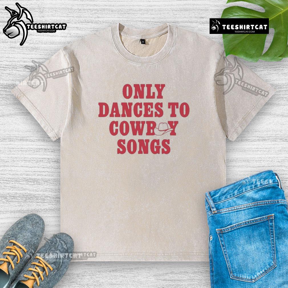 Good George Birge wearing a washed t-shirt, dancing joyfully to cowboy songs at a lively outdoor event.