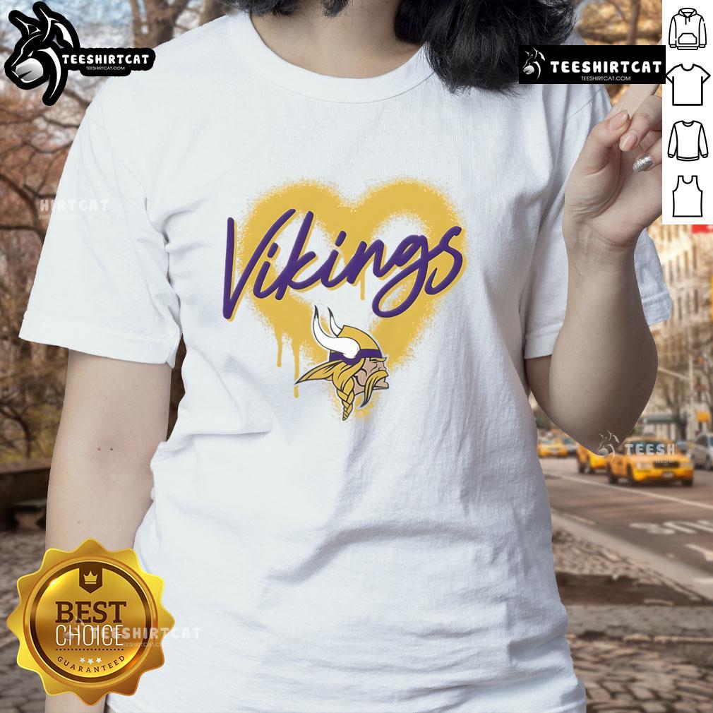 Official Minnesota Vikings Football Spray Heart Ladies Tee, stylish women's shirt featuring Vikings colors and logo.