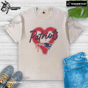 Alt Text: Official New England Patriots Football Spray Heart Washed T-Shirt featuring team colors and logo for fans.