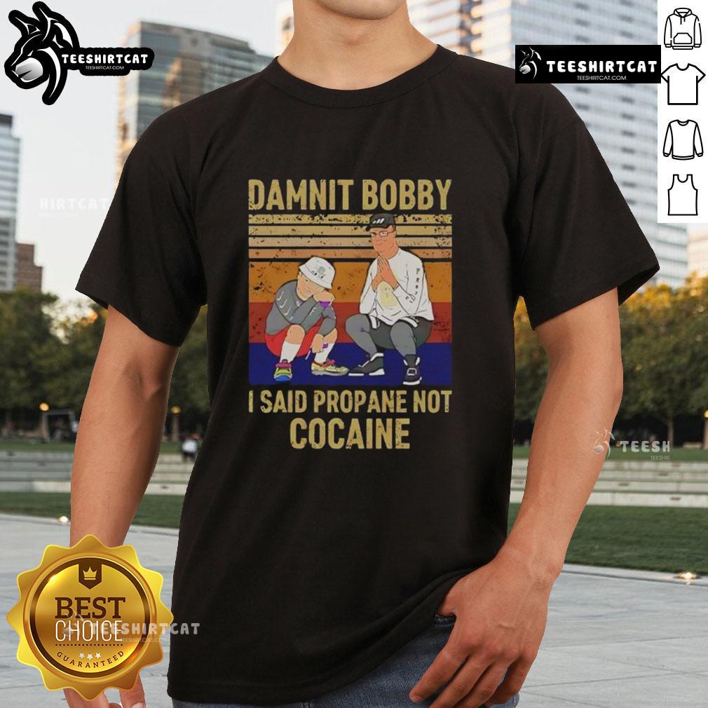 Alt Text: Premium King Of The Hill Hank T-Shirt featuring Damnit Bobby, I said propane not cocaine design. Perfect for fans!