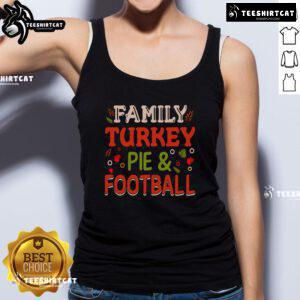 Pretty family enjoying a turkey pie dinner while wearing a football tank top, celebrating togetherness and festive traditions.