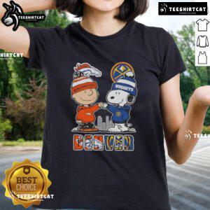 Alt Text: Cute Snoopy and Charlie Brown graphic on a Denver sports Broncos x Nuggets skyline ladies tee shirt.