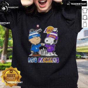 Alt Text: Cute Snoopy and Charlie Brown sweatshirt featuring Los Angeles Dodgers and Lakers skyline design.
