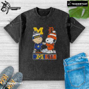 Cute Snoopy and Charlie Brown in Michigan sports Wolverines and Detroit Tigers skyline washed t-shirt design.