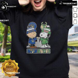 Cute Snoopy and Charlie Brown sweatshirt featuring Milwaukee skyline, supporting Brewers and Bucks sports teams.