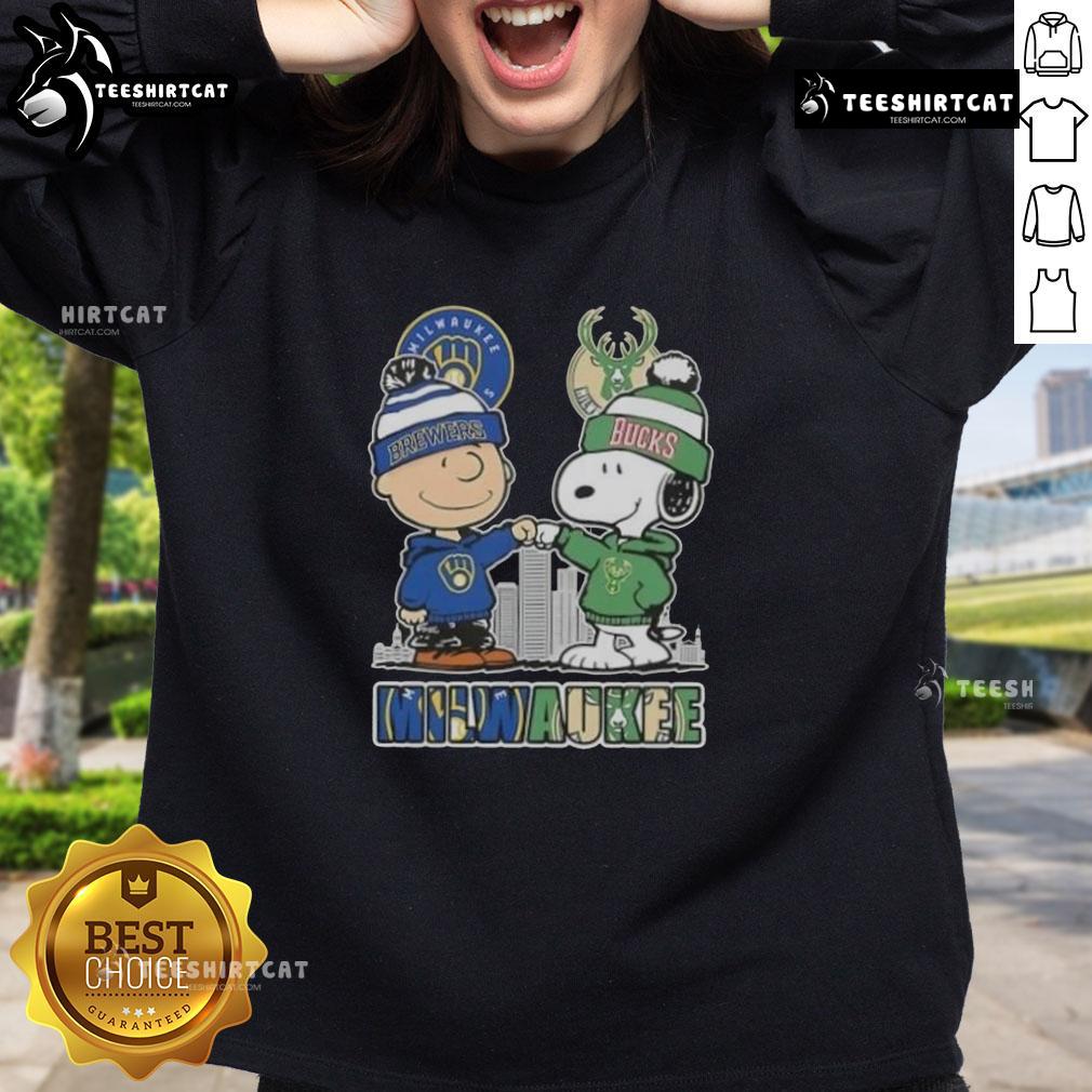 Cute Snoopy and Charlie Brown sweatshirt featuring Milwaukee skyline, supporting Brewers and Bucks sports teams.