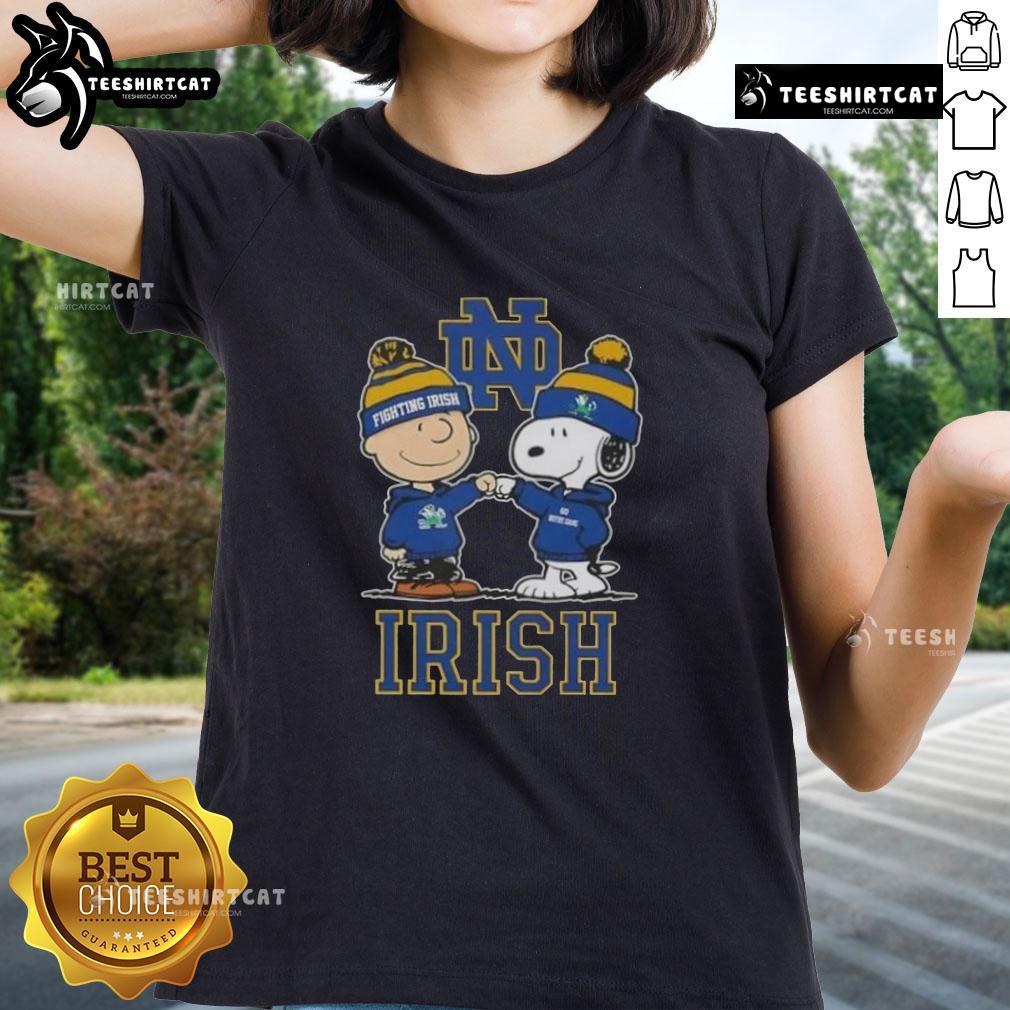 Alt Text: Cute Snoopy and Charlie Brown in Notre Dame Fighting Irish football gear with a skyline, perfect for ladies' tee.