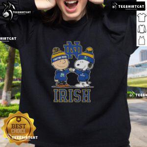 Alt Text: Cute Snoopy and Charlie Brown Notre Dame Fighting Irish football skyline sweatshirt design for fans.