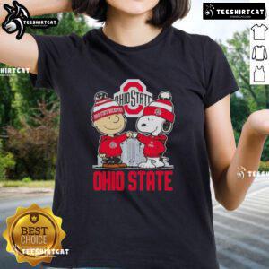 Alt Text: Cute Snoopy and Charlie Brown Ohio State Buckeyes football skyline ladies tee featuring fun cartoon design.
