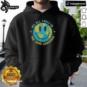 Alt Text: Happy Earth We All Smile In The Same Language hoodie featuring a vibrant design promoting global unity and positivity.