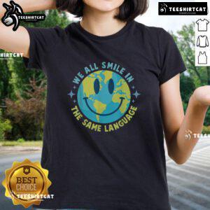 Alt Text: Happy Earth graphic tee for ladies, promoting unity with the slogan 'We All Smile in the Same Language.'