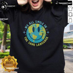 Alt Text: Happy Earth sweatshirt featuring 'We All Smile in the Same Language' design, promoting unity and positivity.