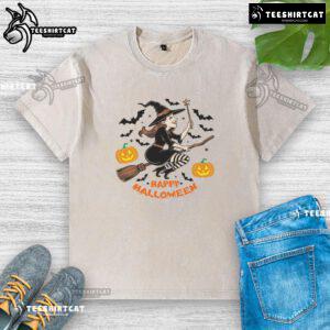 Happy Halloween witch flying on broomstick graphic on a washed t-shirt, perfect for festive celebrations.