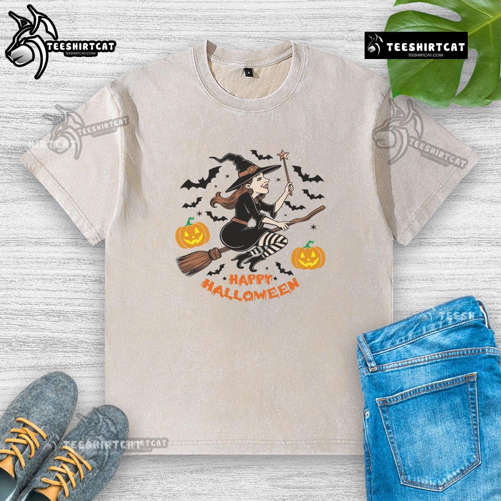 Happy Halloween witch flying on broomstick graphic on a washed t-shirt, perfect for festive celebrations.