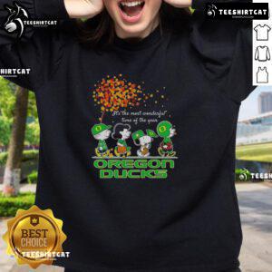 Alt Text: Happy Snoopy and friends in Oregon Ducks sweatshirt celebrating autumn, perfect for sports fans this season.