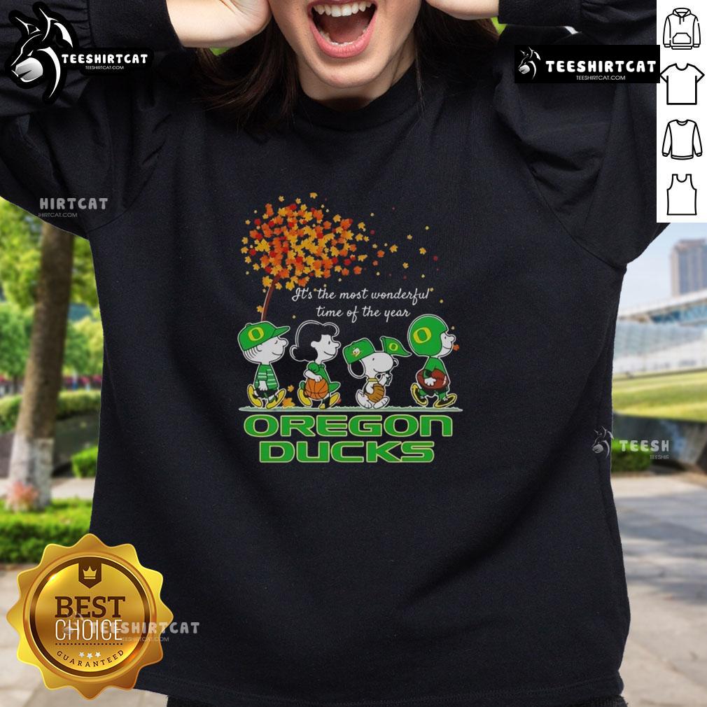 Alt Text: Happy Snoopy and friends in Oregon Ducks sweatshirt celebrating autumn, perfect for sports fans this season.