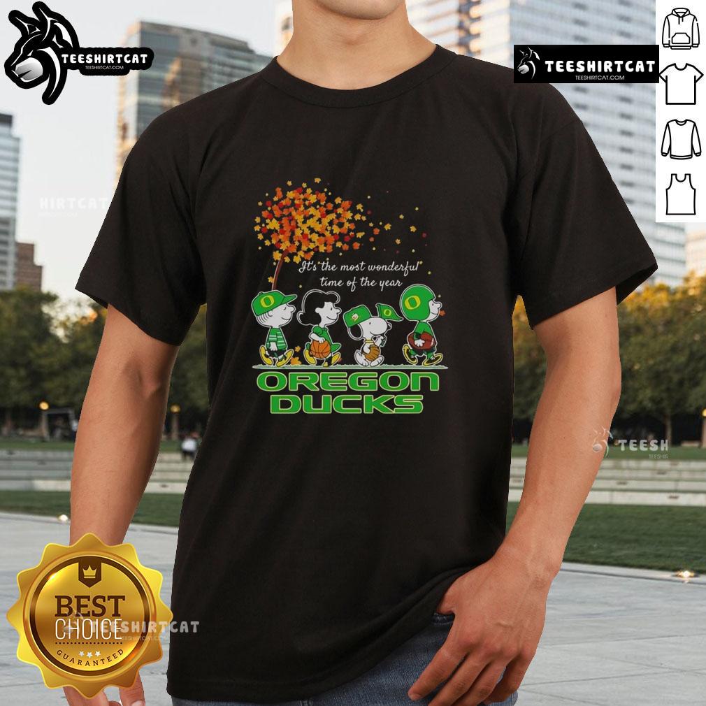 Alt Text: Happy Snoopy and friends on Oregon Ducks autumn t-shirt celebrating the sports team's festive spirit.