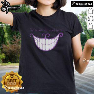 Cheshire Cat smile graphic on a ladies tee, featuring 'We Are All Mad Here' text, perfect for whimsical fashion lovers.